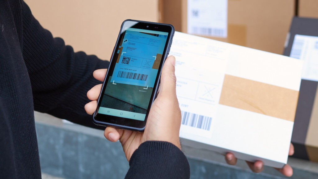 Delivery driver scanning a barcode using a barcode scanner on Android built with React Native.